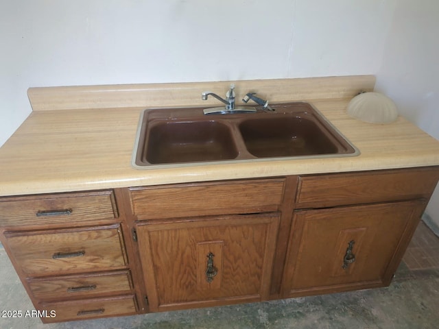 details with brown cabinetry, light countertops, and a sink