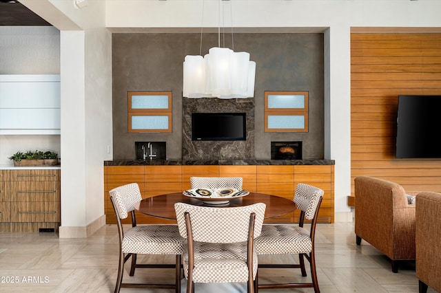 dining room featuring a premium fireplace