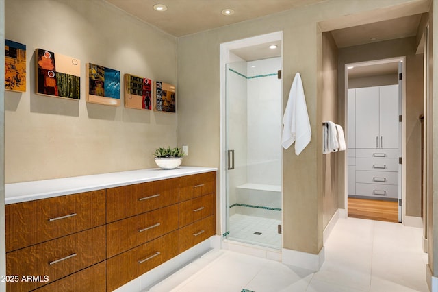 full bath featuring recessed lighting, tile patterned floors, a shower stall, and baseboards