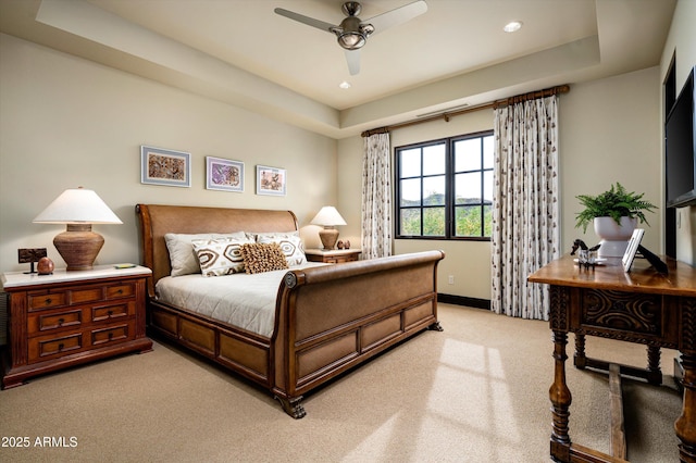 bedroom with baseboards, light carpet, a tray ceiling, and recessed lighting