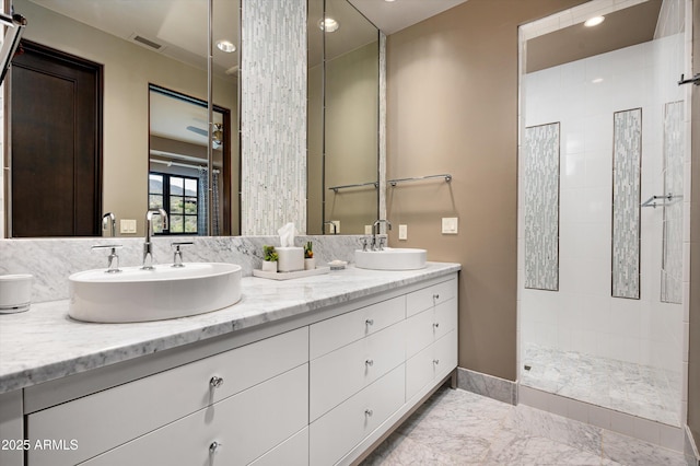 bathroom featuring a sink, walk in shower, and double vanity
