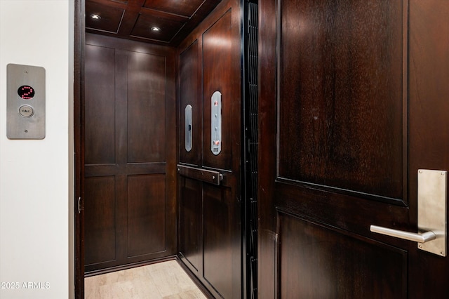room details featuring recessed lighting, elevator, and wood finished floors
