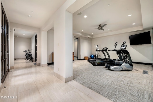 exercise area featuring baseboards, ceiling fan, light carpet, and recessed lighting