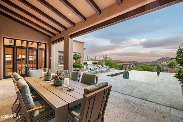 view of patio / terrace featuring an outdoor pool and outdoor dining space