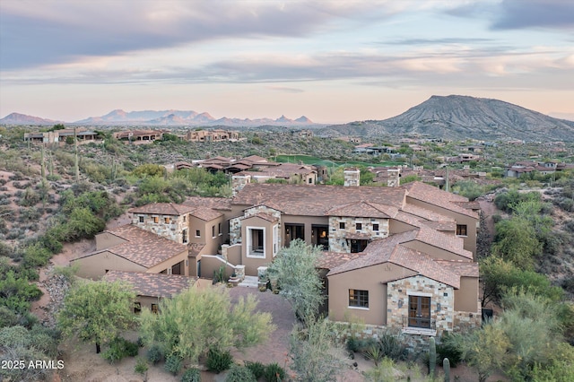 aerial view at dusk with a mountain view and a residential view