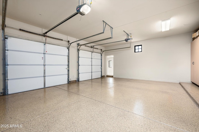 garage with baseboards and a garage door opener