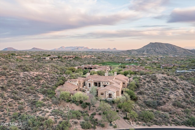 aerial view at dusk featuring a mountain view