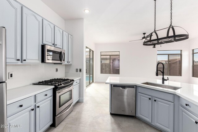 kitchen featuring light tile patterned floors, sink, ceiling fan, a kitchen island with sink, and stainless steel dishwasher