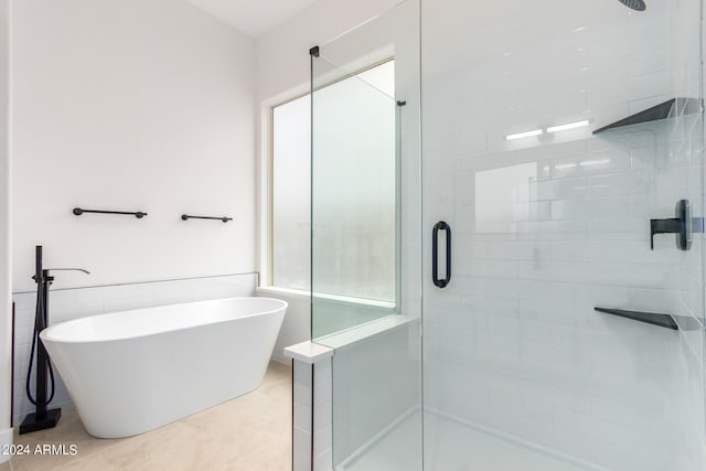 bathroom with separate shower and tub and tile patterned floors