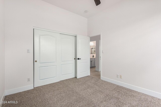 carpeted spare room with ceiling fan