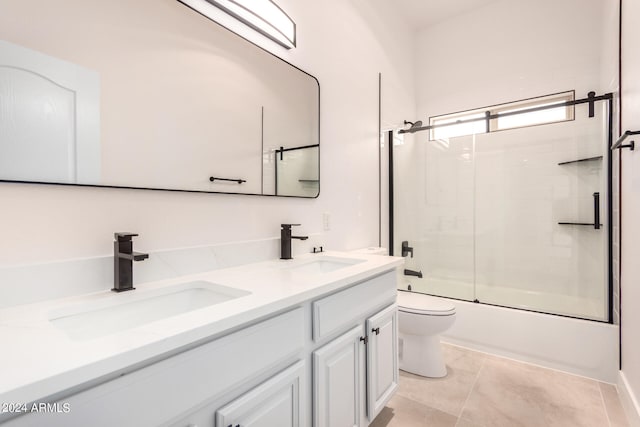 full bathroom with tile patterned floors, enclosed tub / shower combo, toilet, and vanity