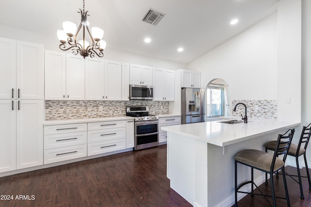 kitchen featuring stainless steel appliances, white cabinets, dark wood-type flooring, and sink