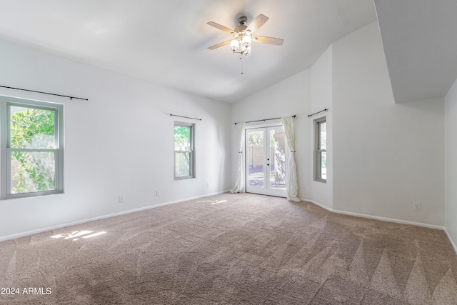 carpeted empty room with high vaulted ceiling and ceiling fan