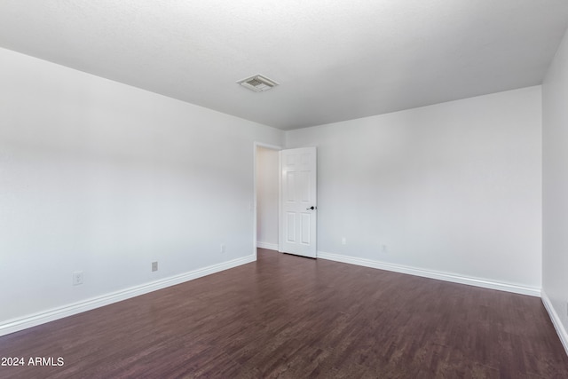 unfurnished room with dark hardwood / wood-style floors