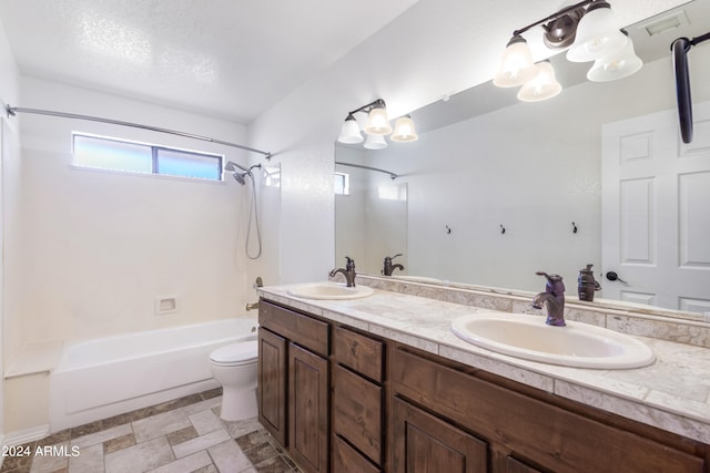 full bathroom with vanity, toilet, shower / bath combination, and a textured ceiling