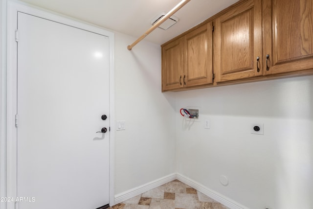 laundry room with cabinets, hookup for an electric dryer, hookup for a gas dryer, and hookup for a washing machine