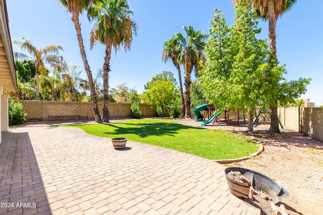 view of yard with a playground and a patio area