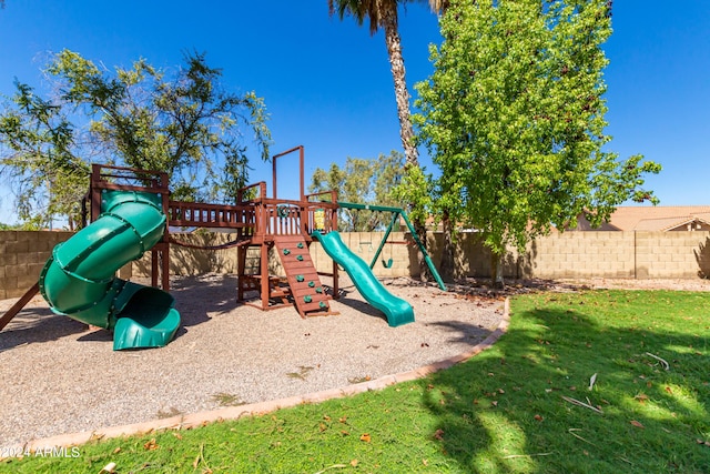 view of jungle gym featuring a lawn