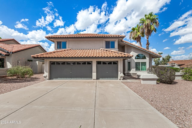 mediterranean / spanish-style home featuring a garage