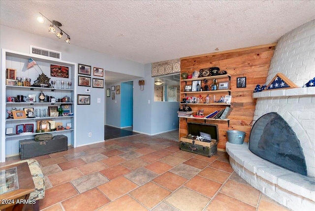 sitting room with a fireplace and a textured ceiling