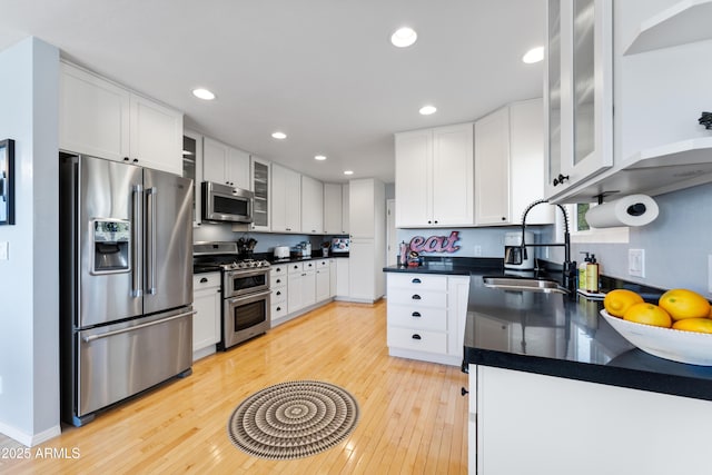 kitchen with white cabinetry, stainless steel appliances, and sink