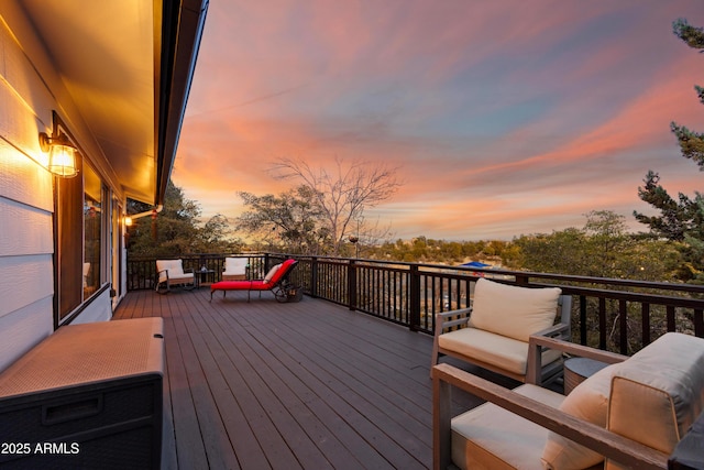 deck at dusk with an outdoor hangout area