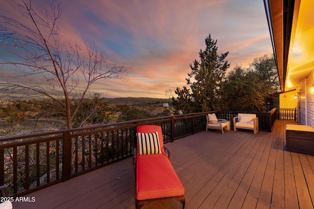 deck at dusk featuring outdoor lounge area