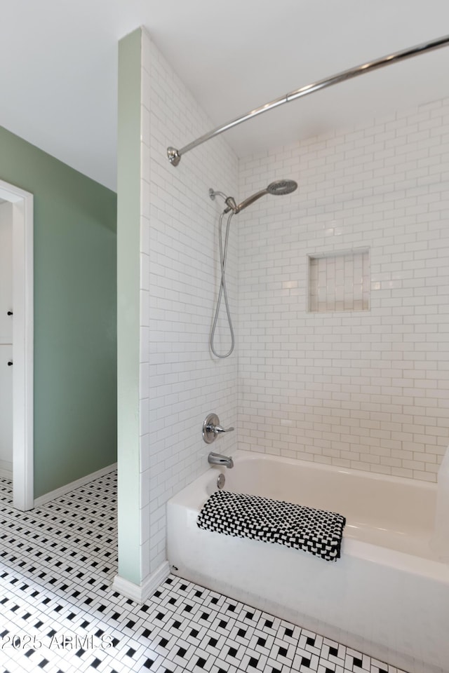 bathroom featuring tiled shower / bath combo and tile patterned floors