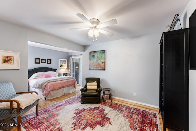 bedroom with wood-type flooring, ceiling fan, and a closet