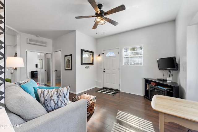 living room with dark wood-type flooring, a wall mounted AC, and ceiling fan