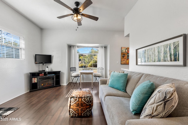 living room with ceiling fan and dark hardwood / wood-style flooring