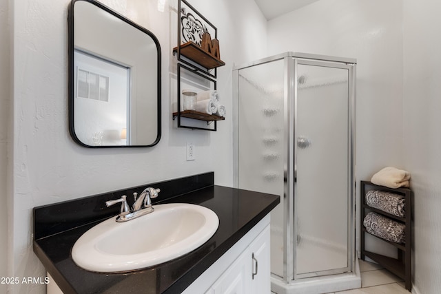 bathroom with a shower with door and vanity