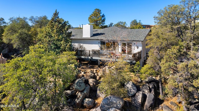 back of property featuring a deck