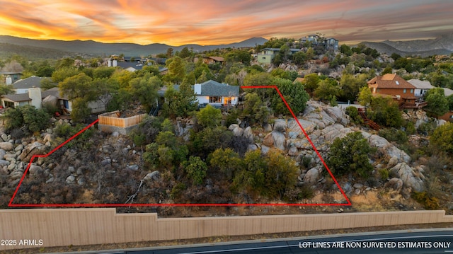 aerial view at dusk featuring a mountain view