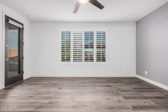 unfurnished room with wood-type flooring and ceiling fan