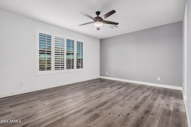 empty room with ceiling fan and hardwood / wood-style flooring