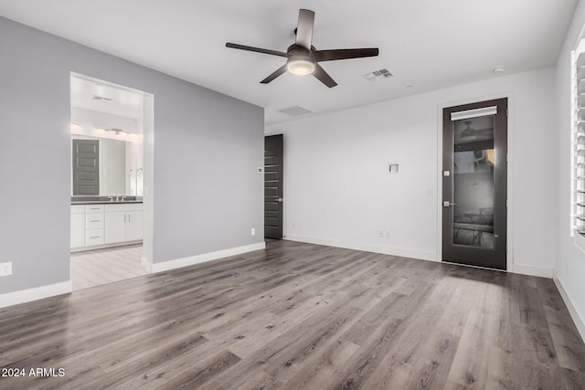 unfurnished living room with ceiling fan, sink, and light hardwood / wood-style floors