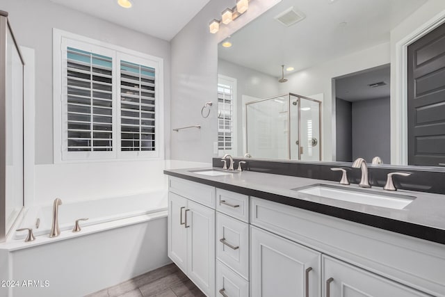 bathroom featuring vanity and plus walk in shower