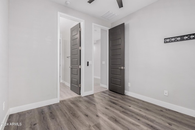 unfurnished bedroom featuring ceiling fan and light wood-type flooring