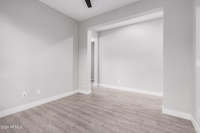 empty room with light wood-type flooring and ceiling fan