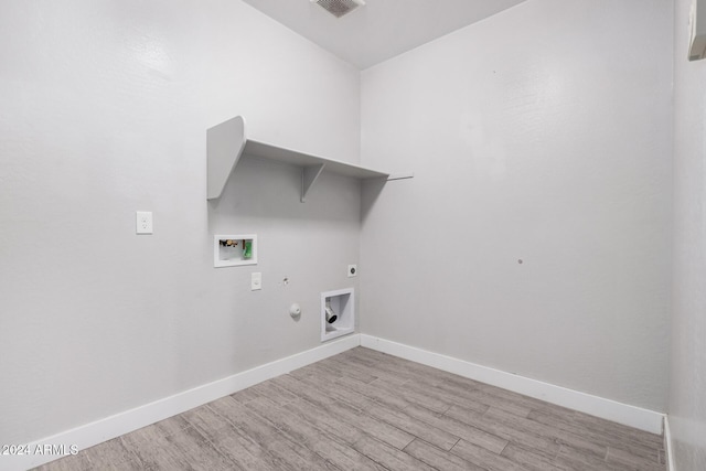 laundry area featuring electric dryer hookup, hookup for a gas dryer, light hardwood / wood-style flooring, and washer hookup