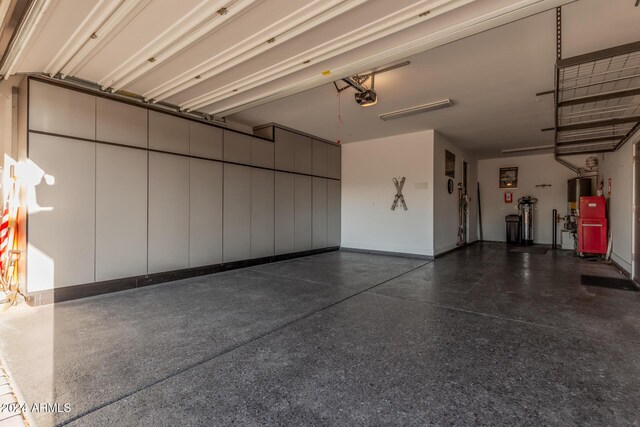 garage featuring gas water heater and a garage door opener