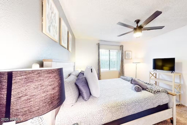 carpeted bedroom featuring a textured ceiling and a ceiling fan