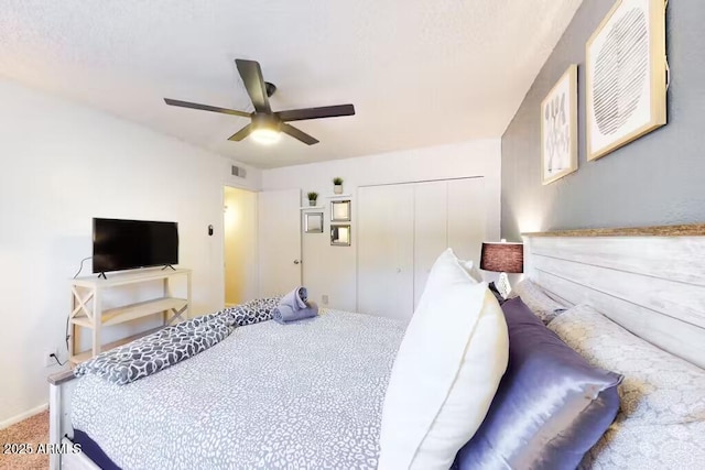 bedroom with a closet, a ceiling fan, and carpet