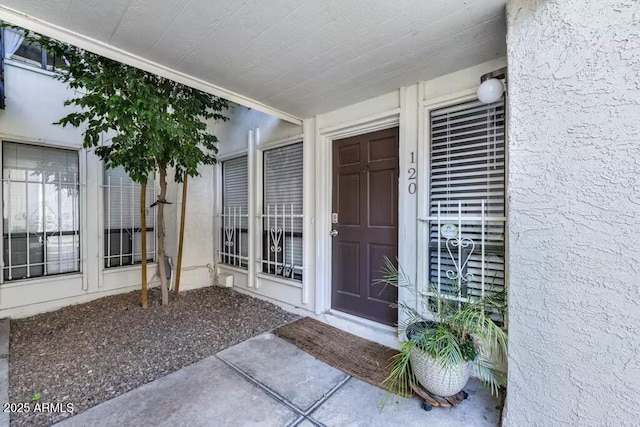 entrance to property with stucco siding
