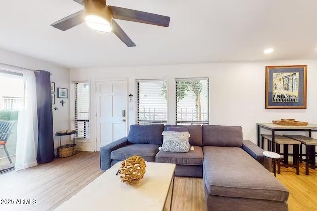 living area featuring ceiling fan, plenty of natural light, light wood finished floors, and recessed lighting