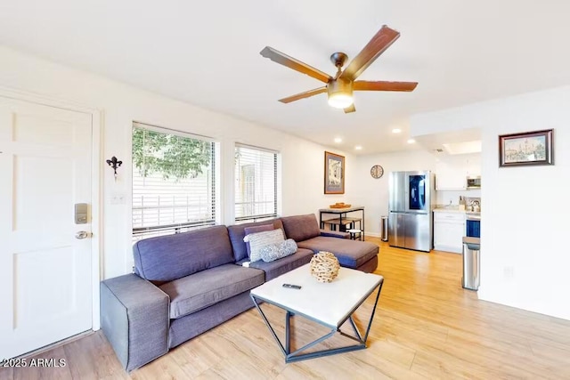 living area with light wood finished floors, ceiling fan, and recessed lighting
