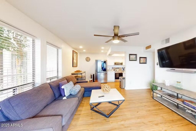 living room with light wood-style flooring, ceiling fan, and recessed lighting