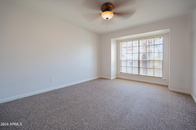 unfurnished room featuring ceiling fan and carpet flooring