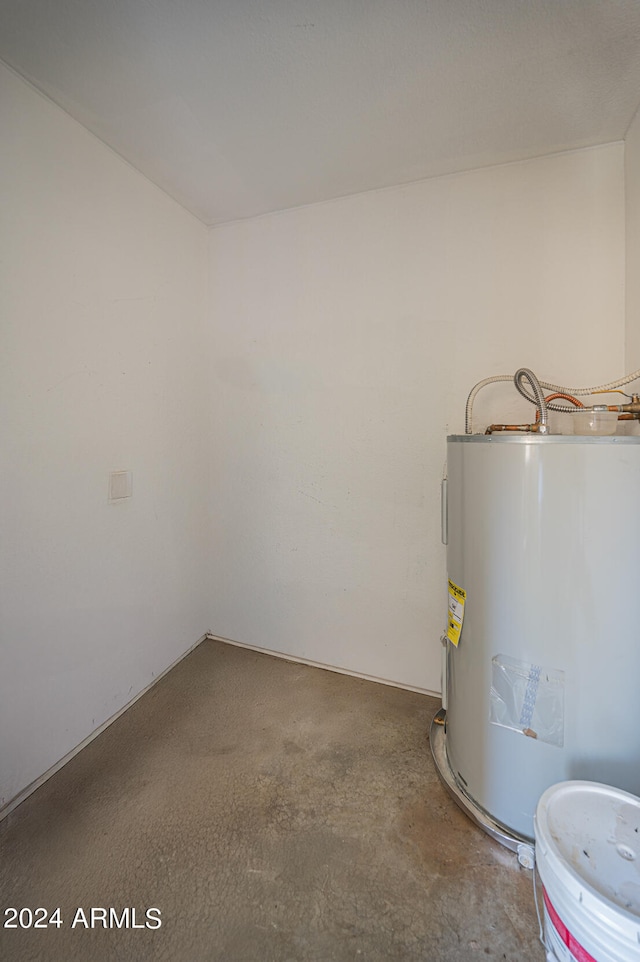 utility room featuring water heater